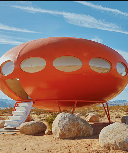 brightly-coloured-red-ufo-house-in-the-middle-of-a-desert