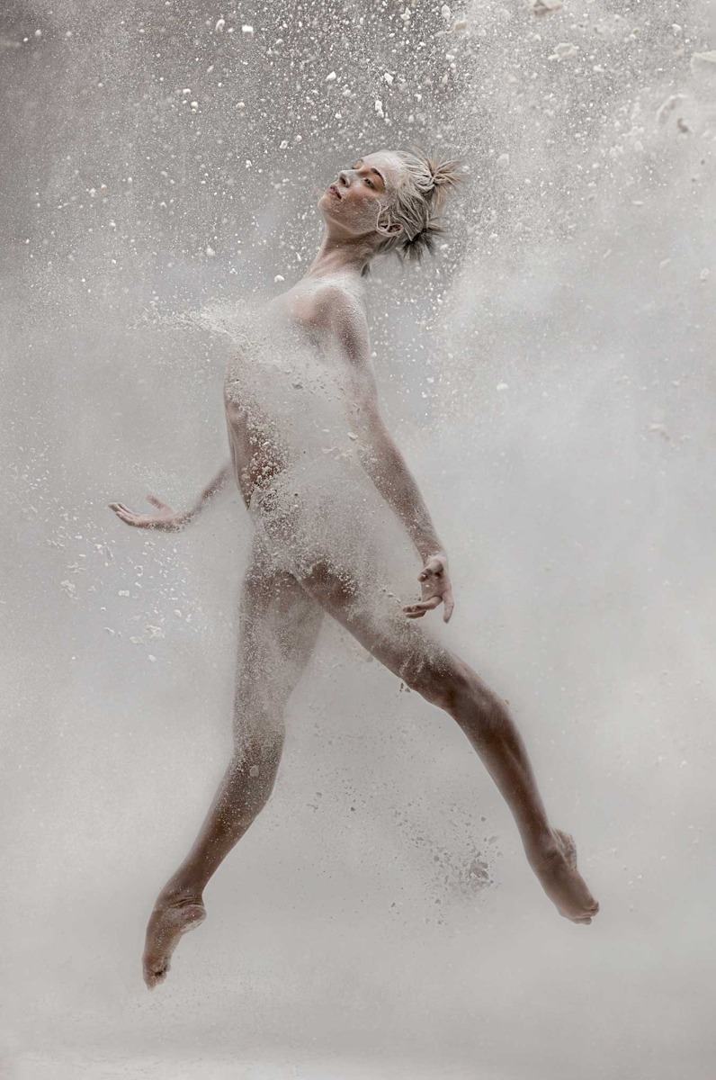 full-length-dancer-mid-jump-in-a-dust-cloud