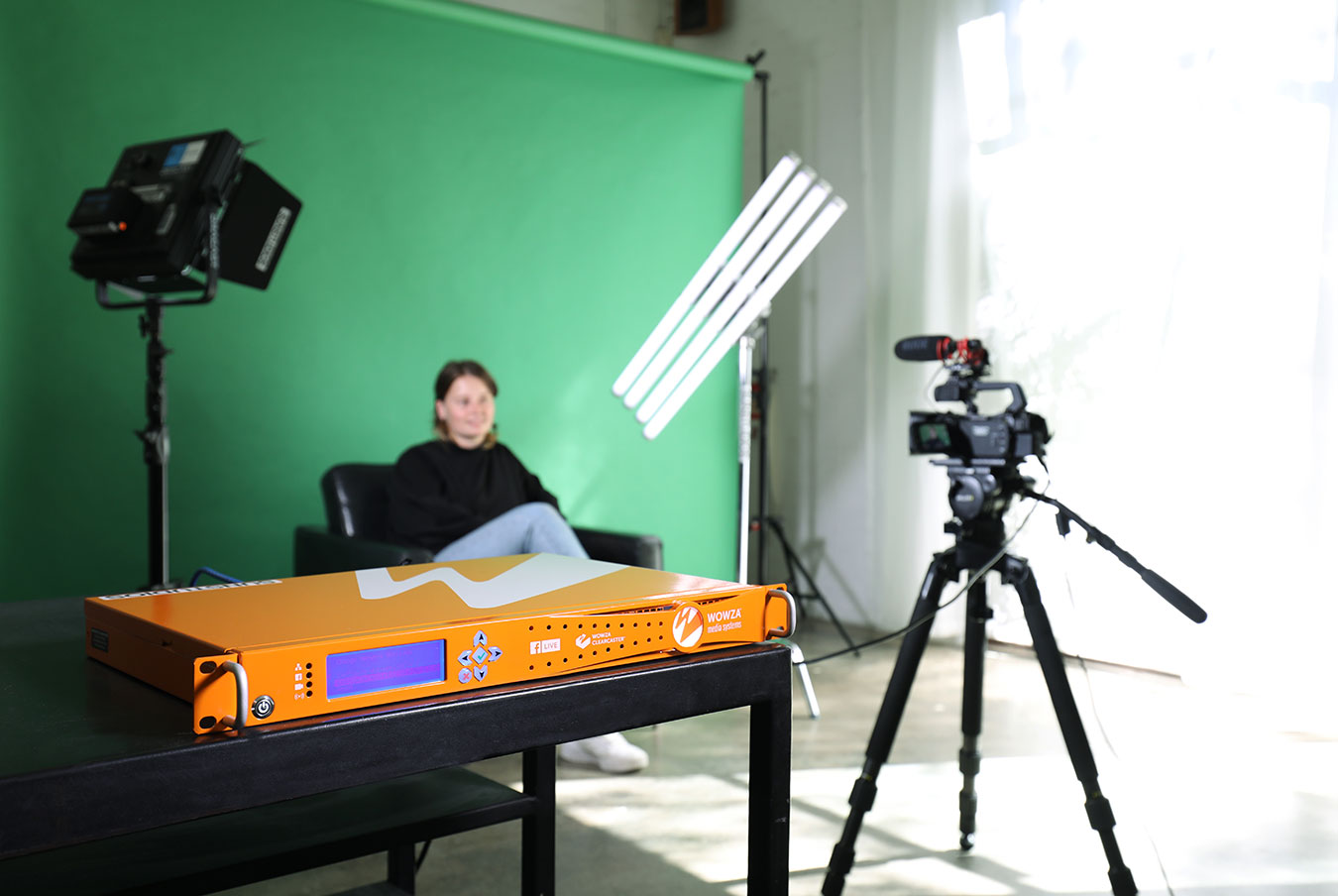 woman-being-filmed-in-front-of-a-green-screen-under-lights-clearcaster-pro-in-foreground