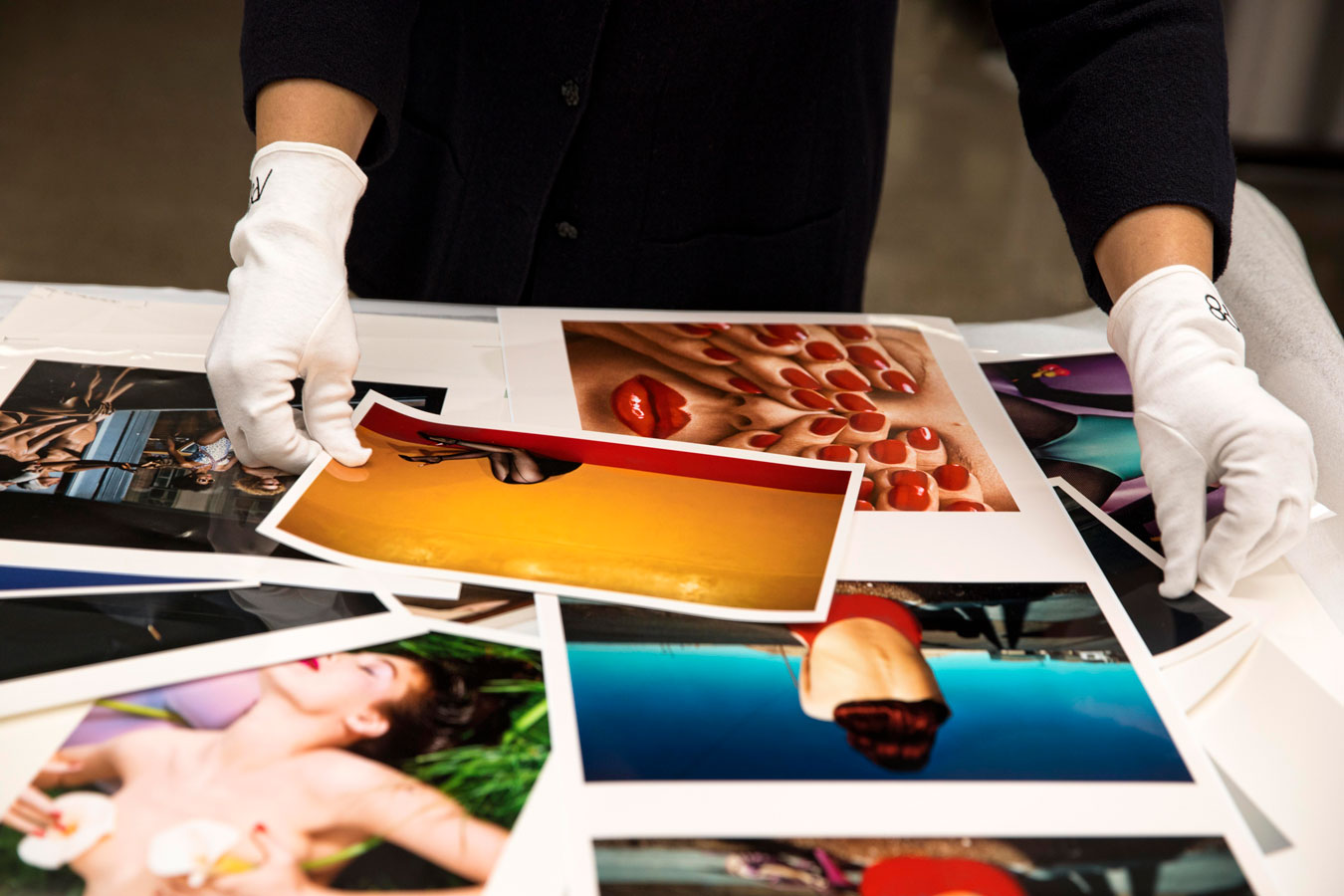 close-up-of-white-gloved-hands-considering-test-prints