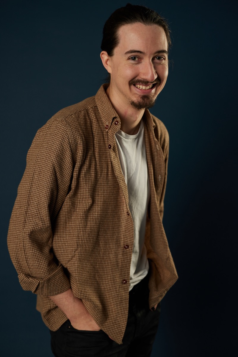 Jake Halfhyde standing against a dark background