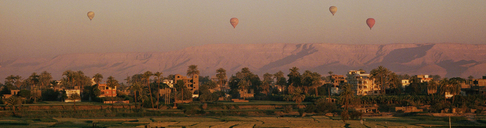 hot-air-balloons-seen-rising-at-sunset-from-across-the-nile-river