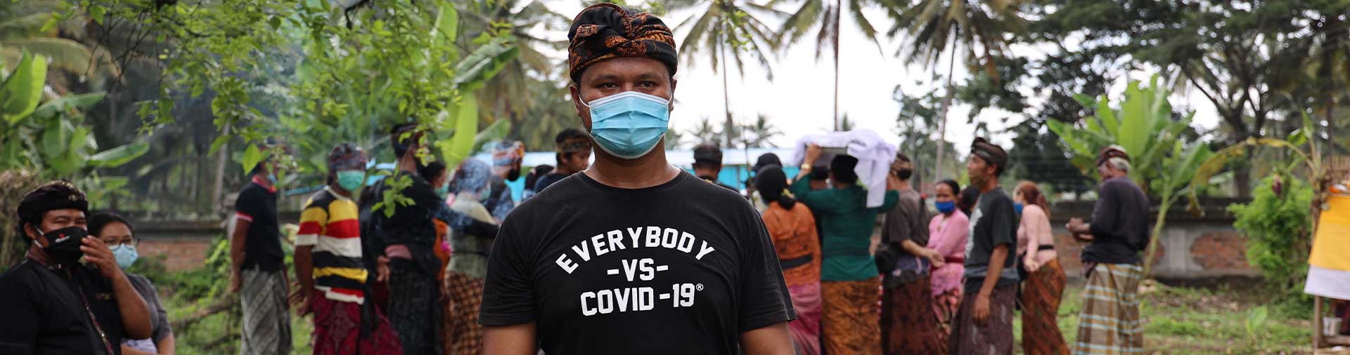 balinese-man-in-mask-wearing-black-everybody-against-covid-t-shirt