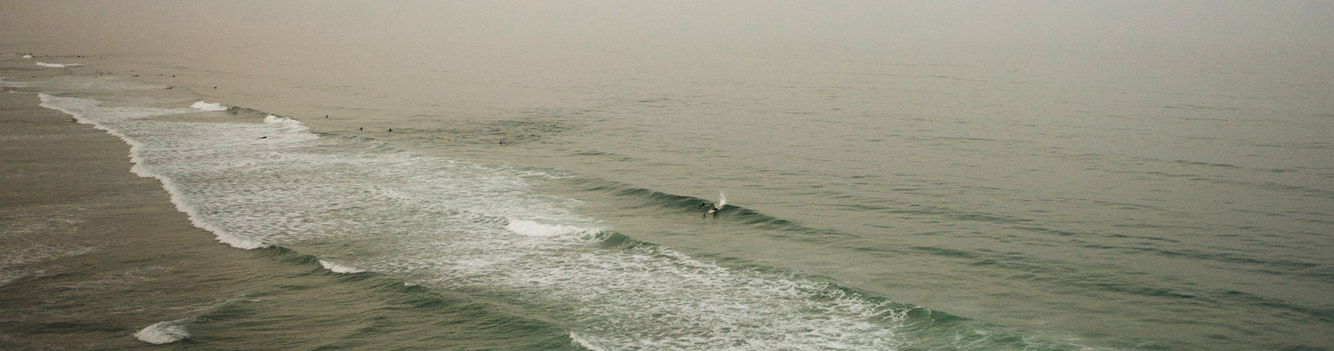 green-vast-ocean-small-surfing-figure