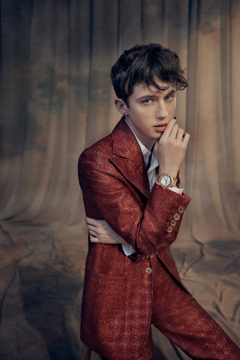 pop-star-troye-sivan-with-hand-on-face-behind-pink-toned-backdrop