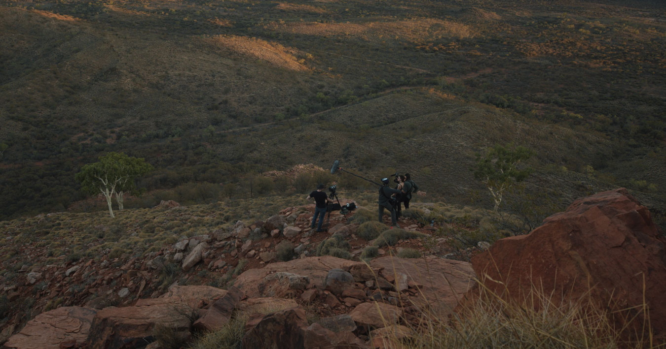 film-crew-in-the-australian-landscape-small-in-the-frame-of-vast-rocky-earth