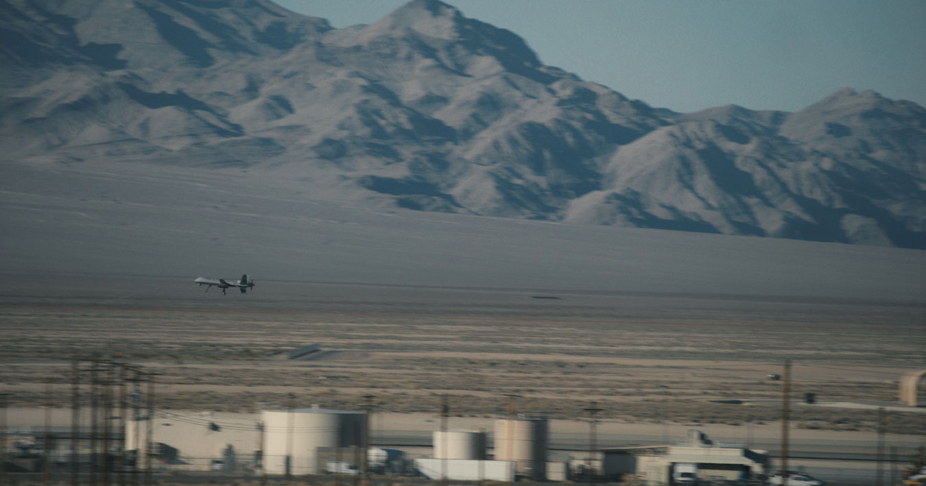 a-miltary-style-drone-taking-off-with-blurred-nevada-desert-landscape-behind