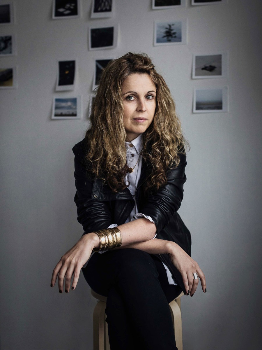 portrait-of-sinead-mcdevitt-with-backdrop-of-photographic-prints