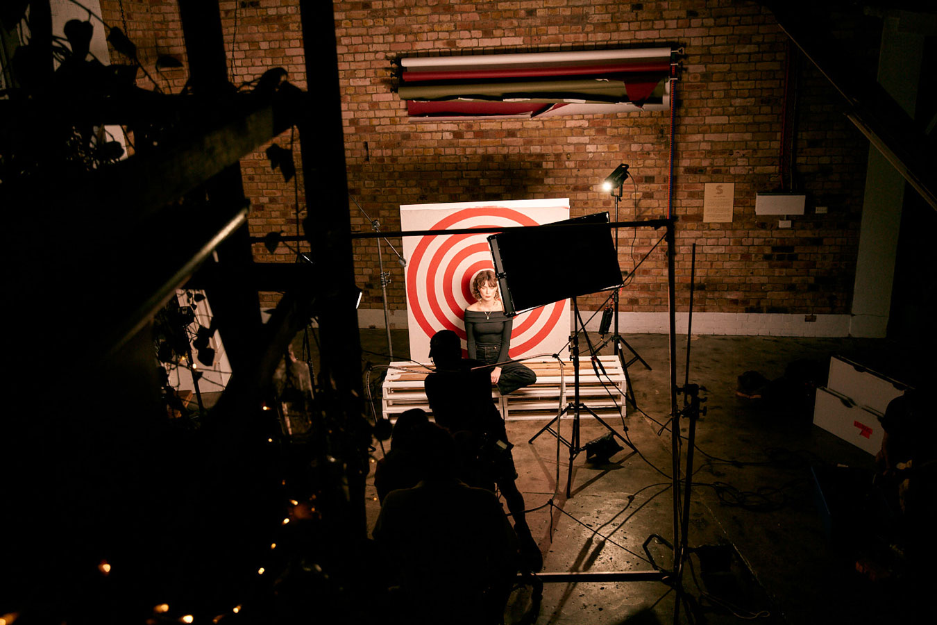 nehind-the-scenes-on-film-clip-shoot-woman-among-lighting-in-foront-of-a-target