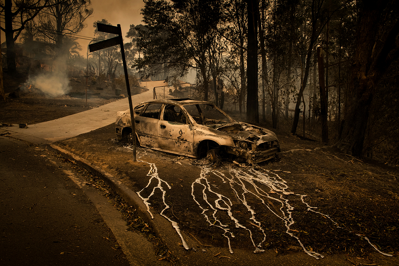 a-destroyed-car-melted-on-a-street-corner-at-conjola-park-by-matthew-abbott-for-the-new-york-times