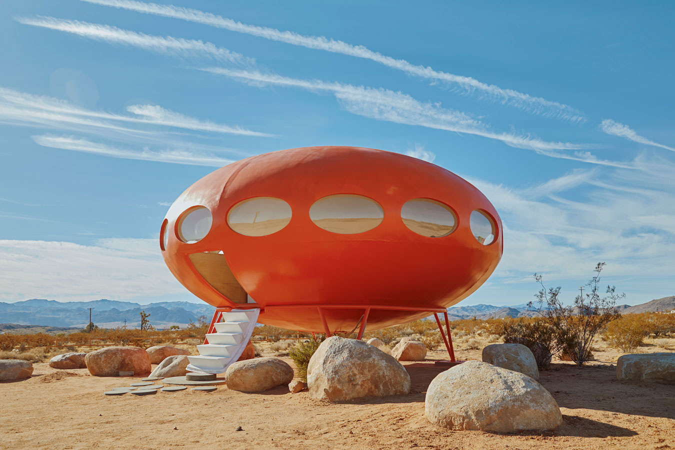 brightly-coloured-red-ufo-house-in-the-middle-of-a-desert