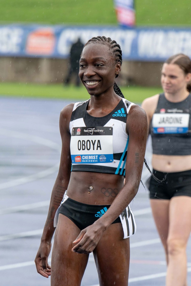 athlete-smiling-in-the-rain-on-the-racetrack