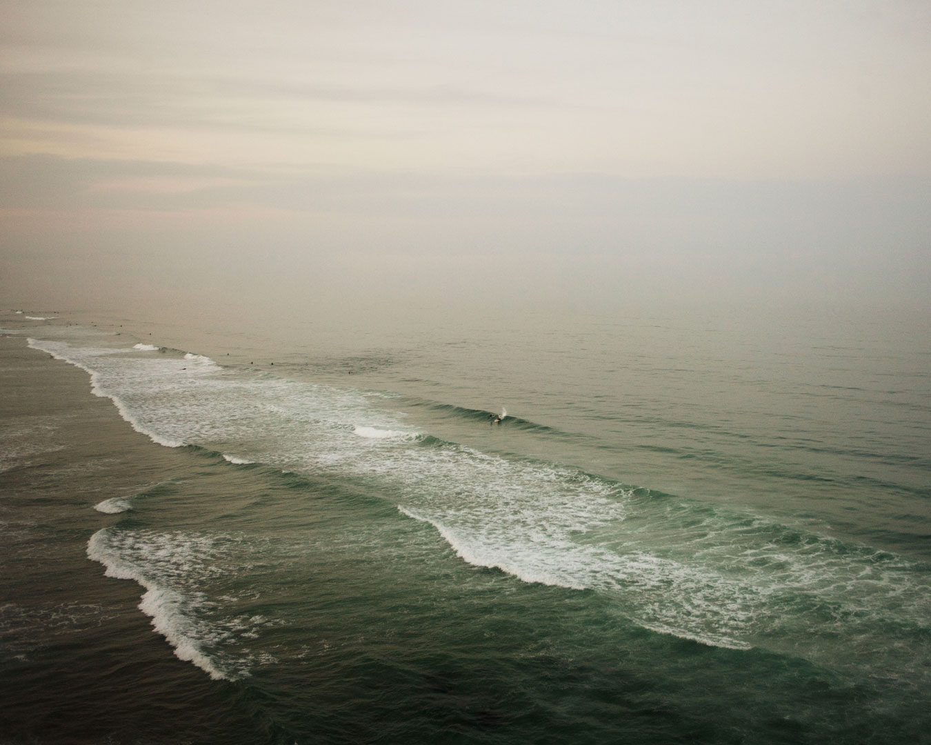 green-vast-ocean-small-surfing-figure