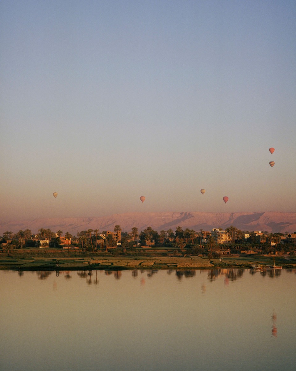 hot-air-balloons-seen-rising-at-sunset-from-across-the-nile-river