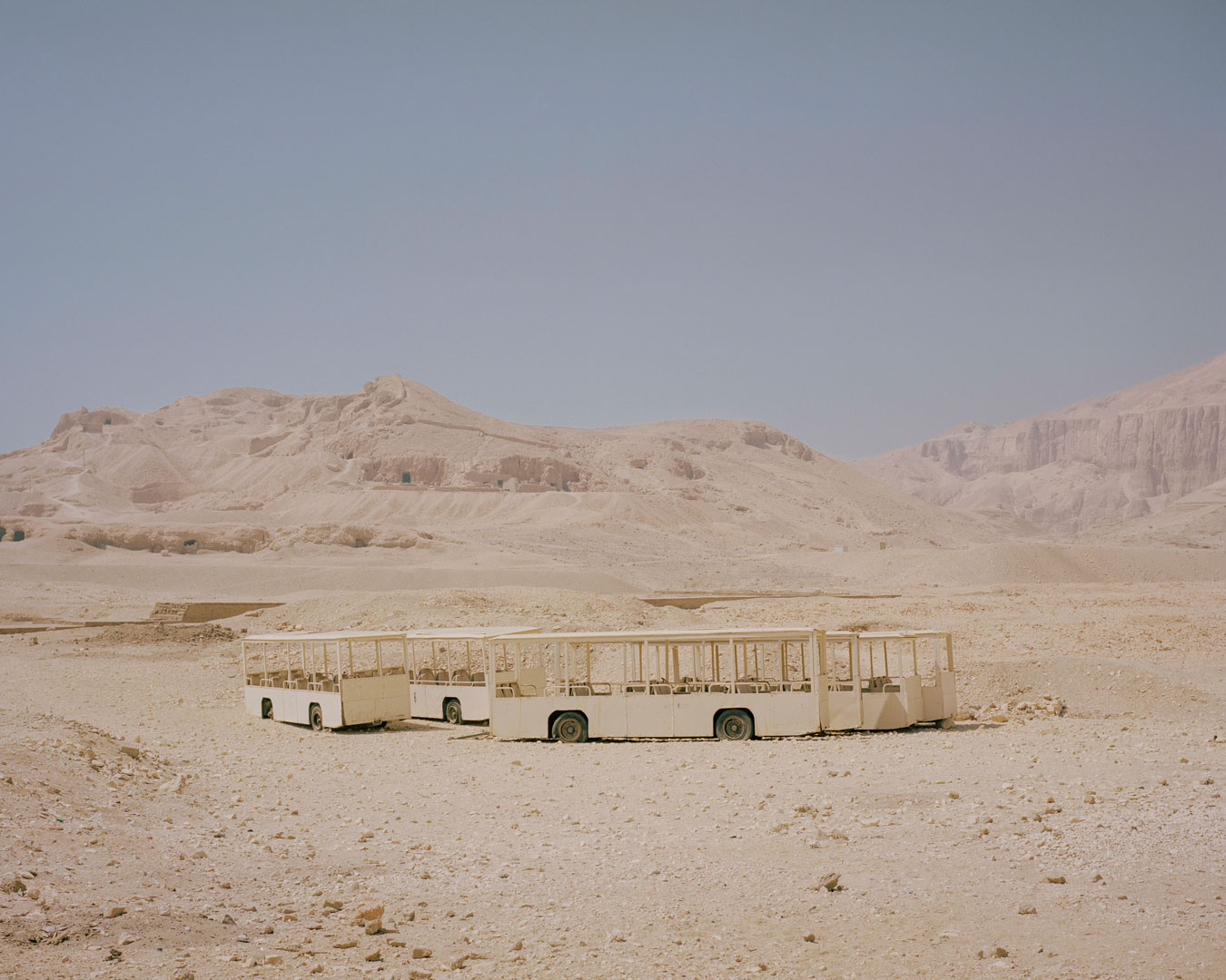 egyptian-sand-coloured-landscape-with-sandcoloured-bus-structures-mid-frame