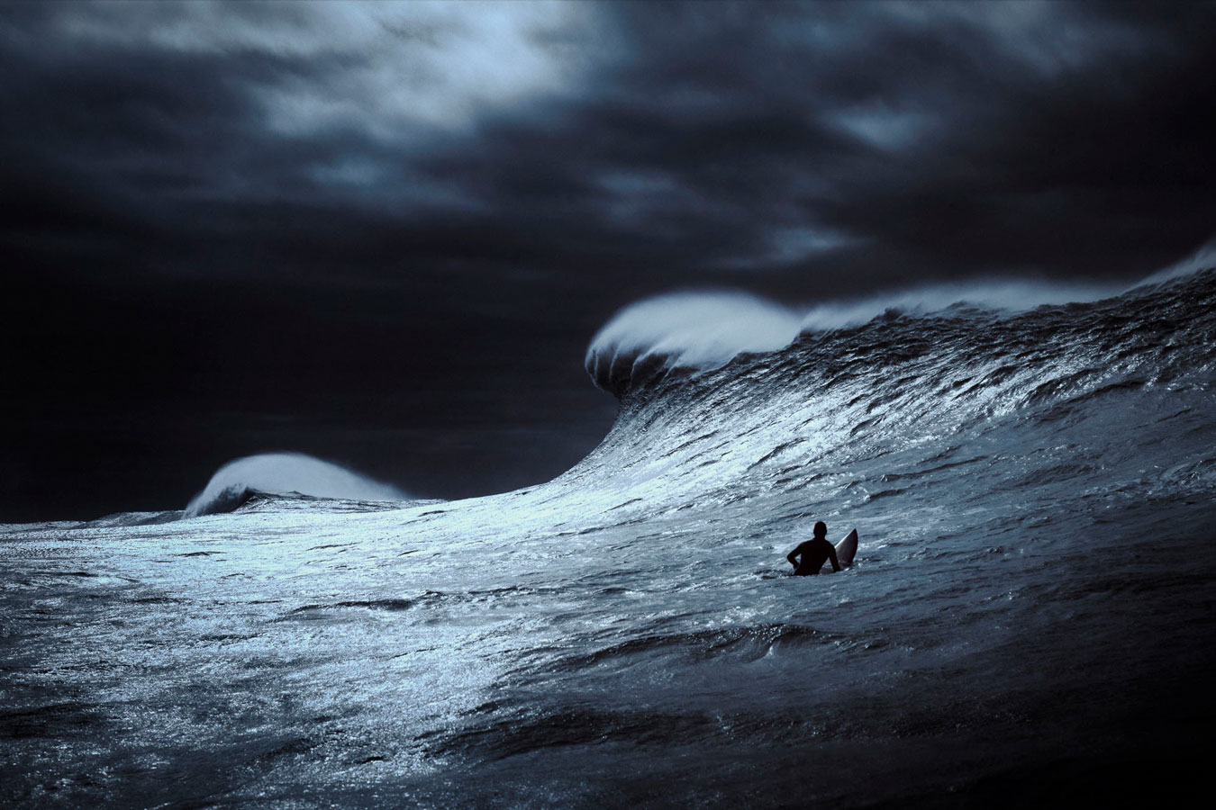 small-figure-dwarfed-by-large-wave