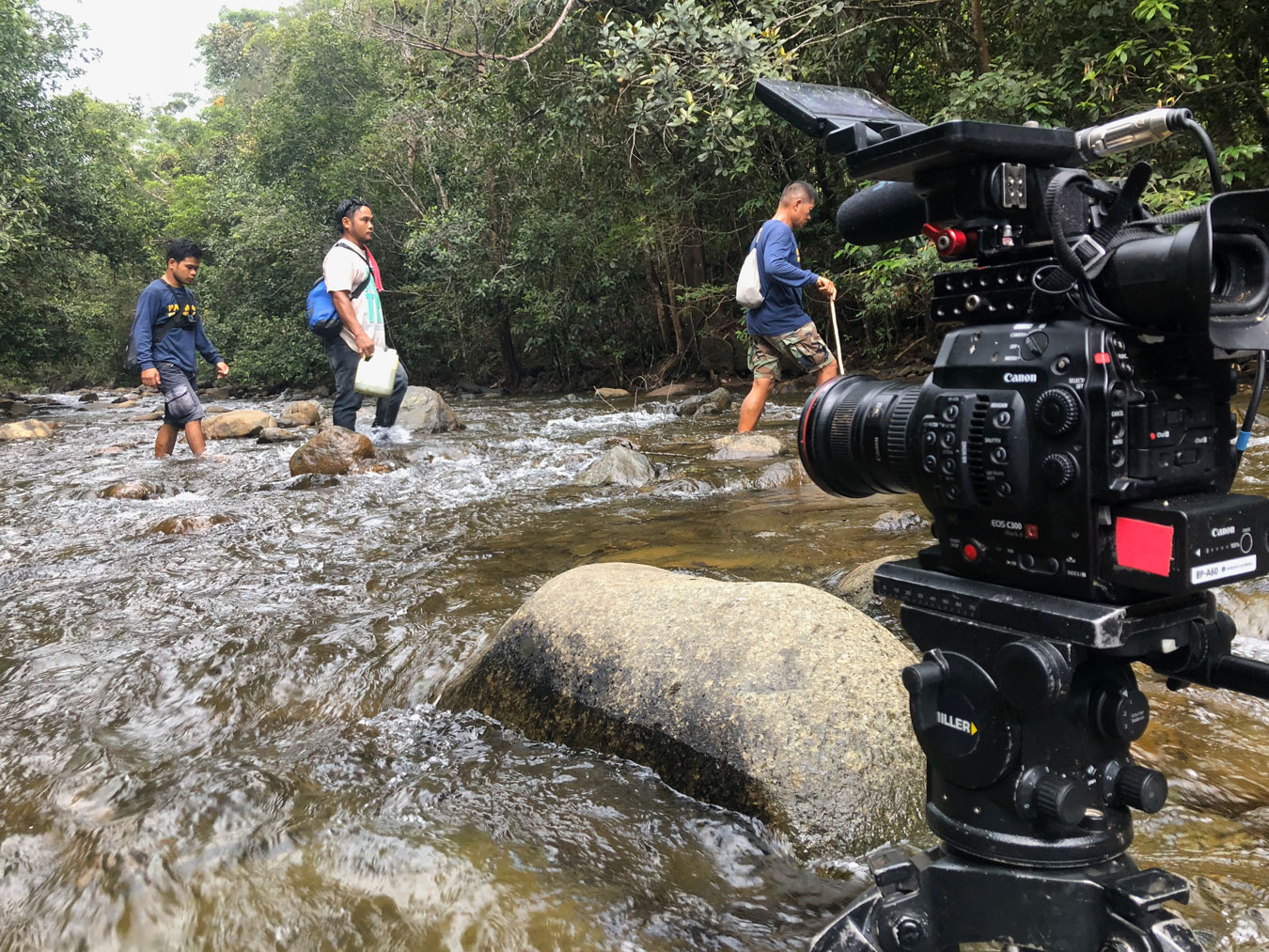 a canon-cinema-body-is-set-to-film-men-crossing-a-forest-river