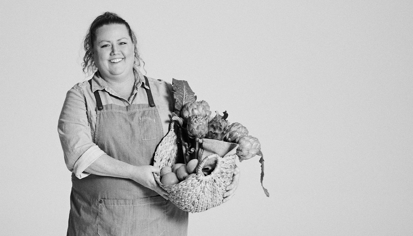 black-and-white-image-of-natalie-jaeger-holding-basket-of-produce-by-kristina-yenko