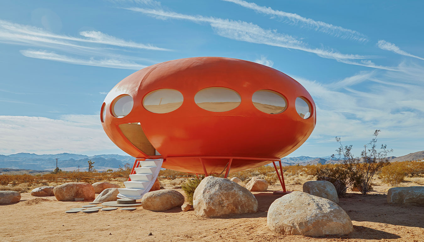 brightly-coloured-red-ufo-house-in-the-middle-of-a-desert