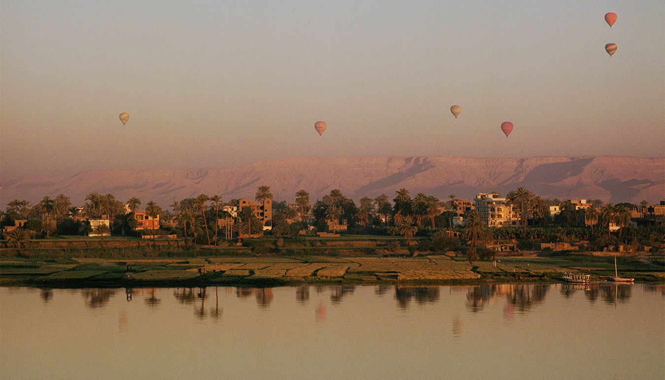 hot-air-balloons-seen-rising-at-sunset-from-across-the-nile-river 