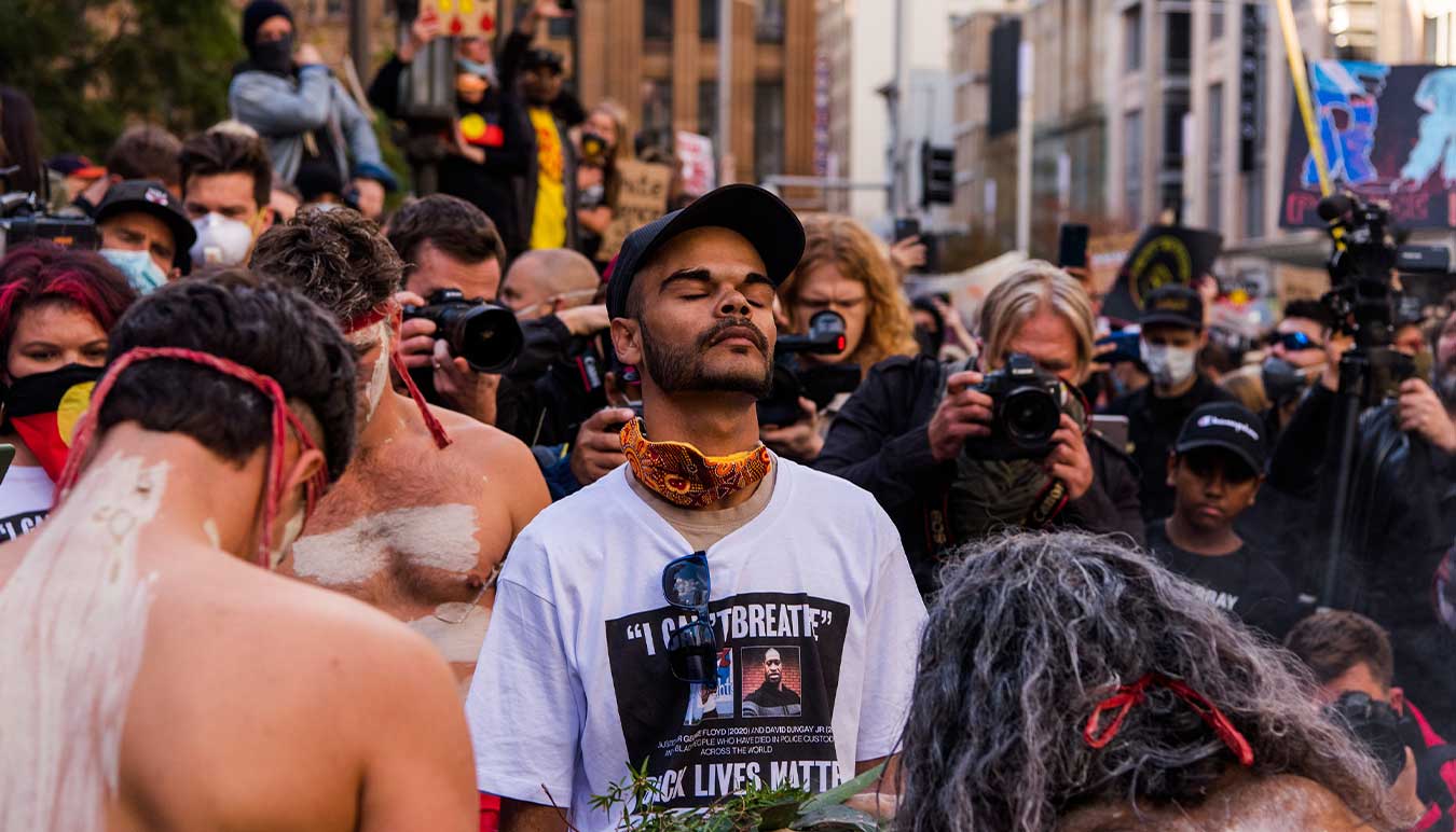 david-dungays-nephew-paul-silva-stands-in-a-crowd-taking-a-moment-with-his-eyes-closed-and-back-turned-to-many-photographers-image-by-james-brickwood