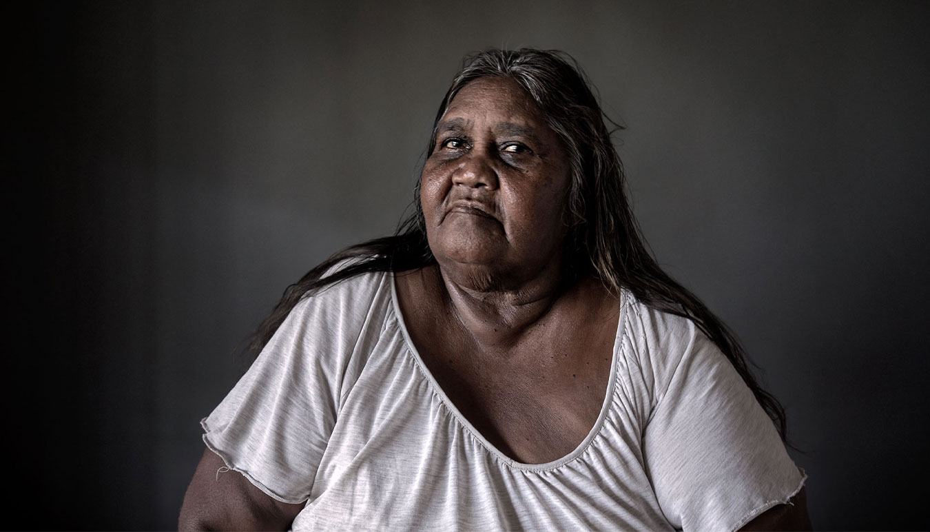 indigenous-australian-woman-in-white-tshirt-eyes-to-camera