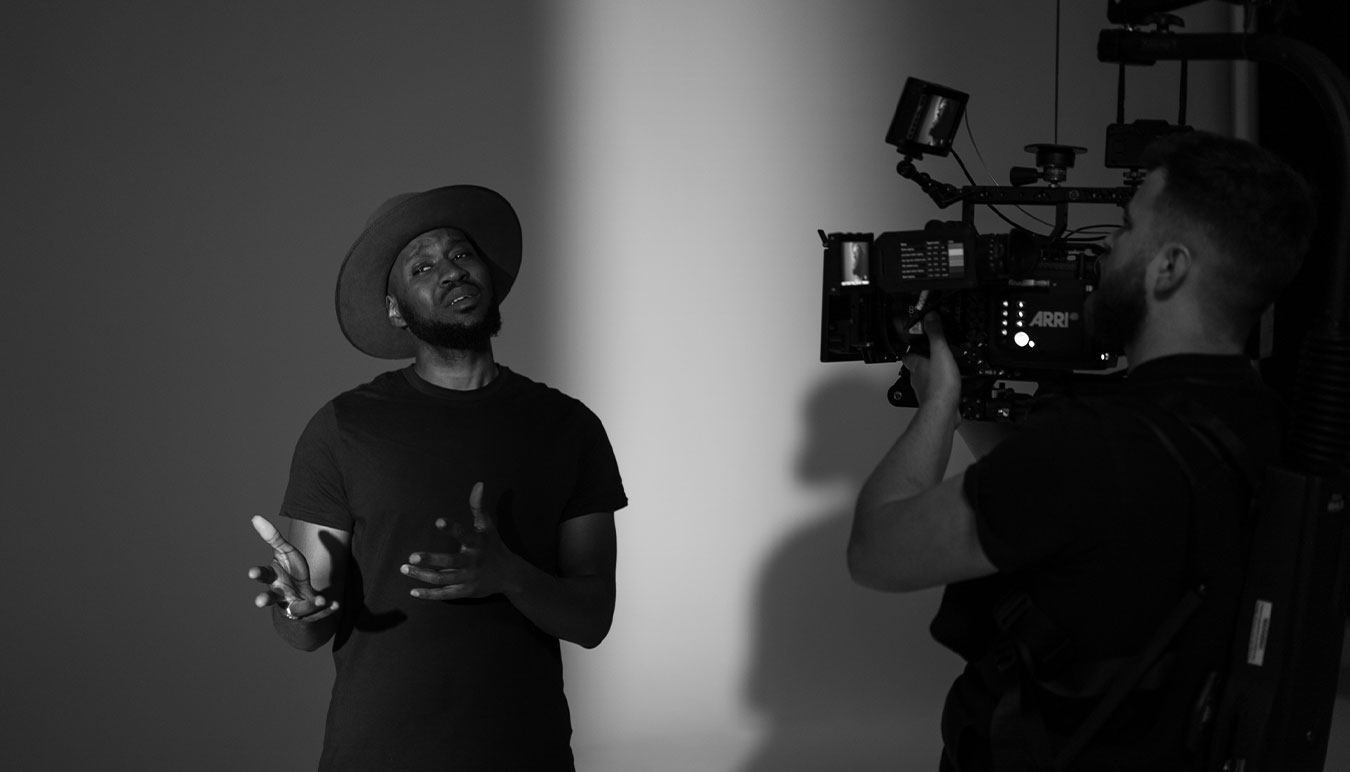 man-in-studio-singing-while-filmed